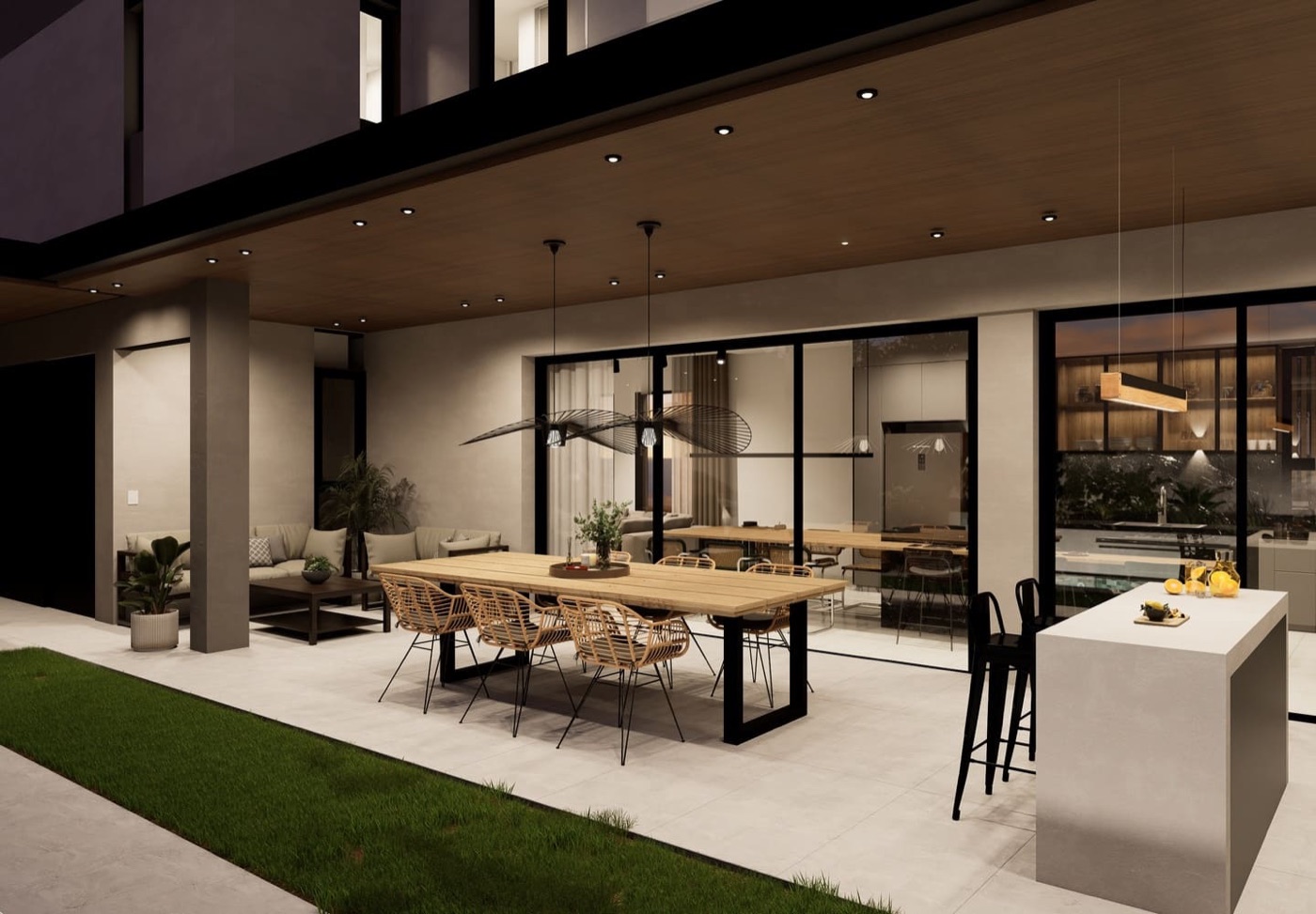 Render nocturno de la galería de una casa de Housen: comedor exterior, cocina y living
